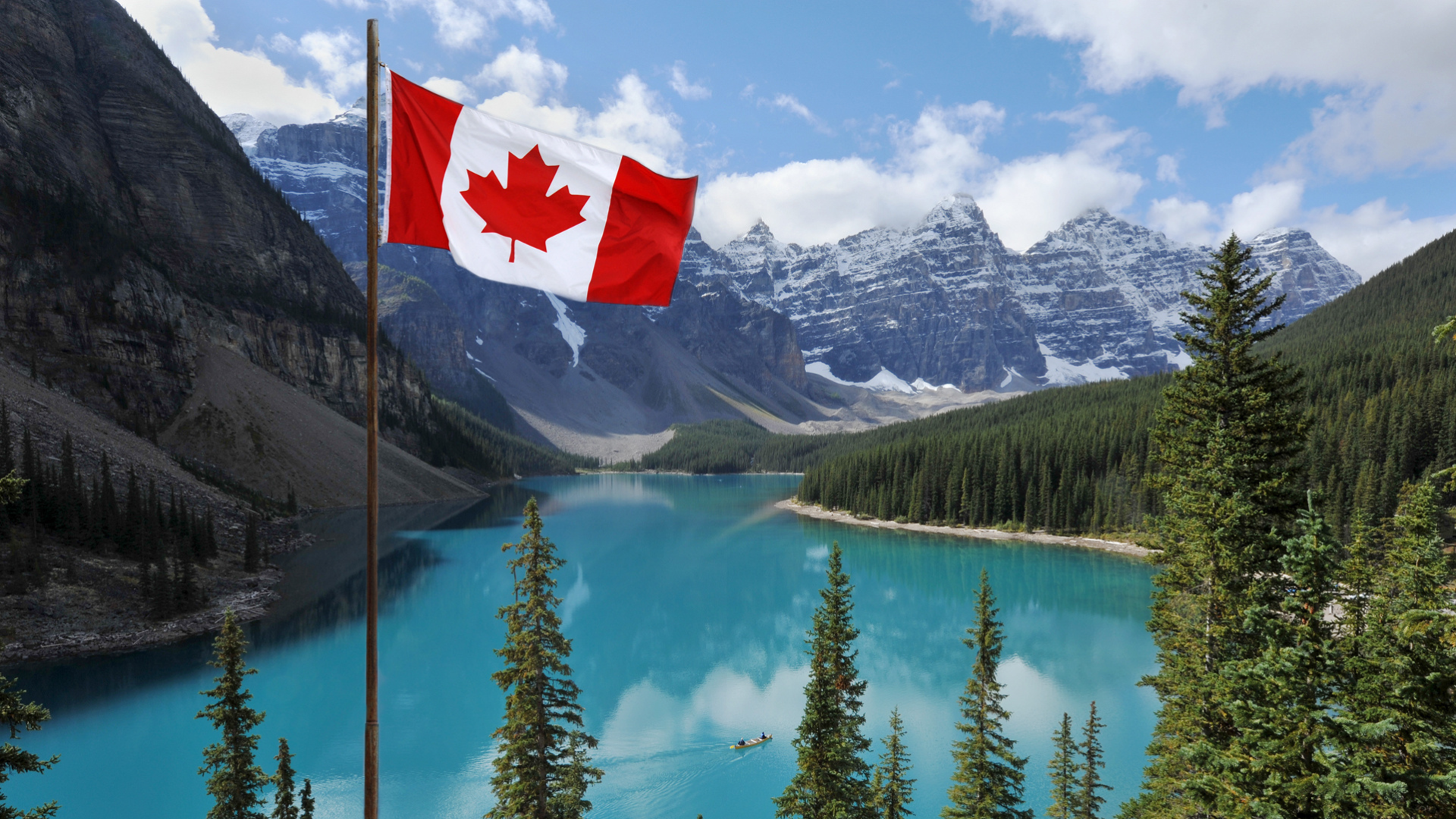 Photo of trees and lake with Canadian flag