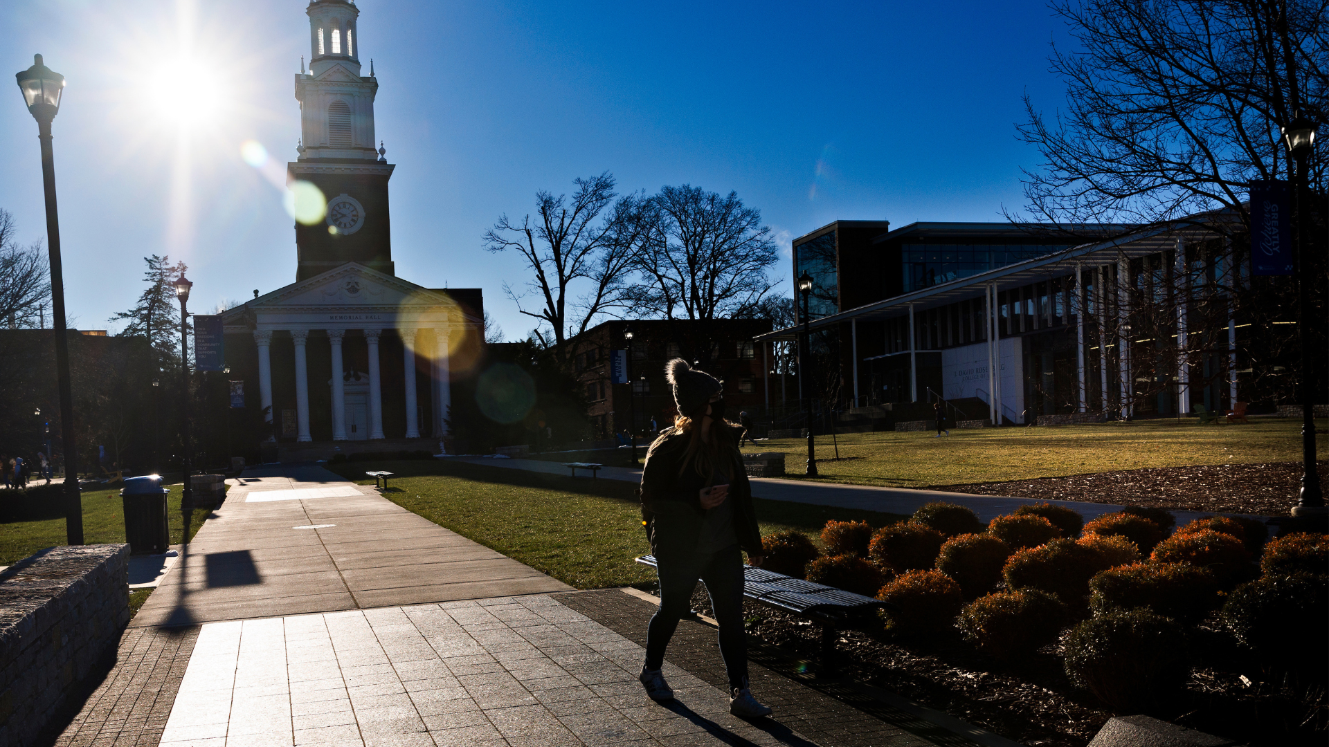 Student walking on path in front of Memorial Hall on UK's campus