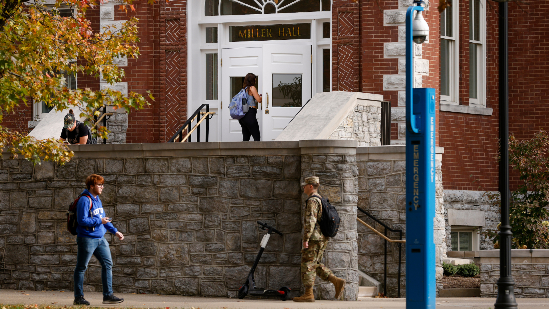 Four students walking around Miller Hall (building on campus)