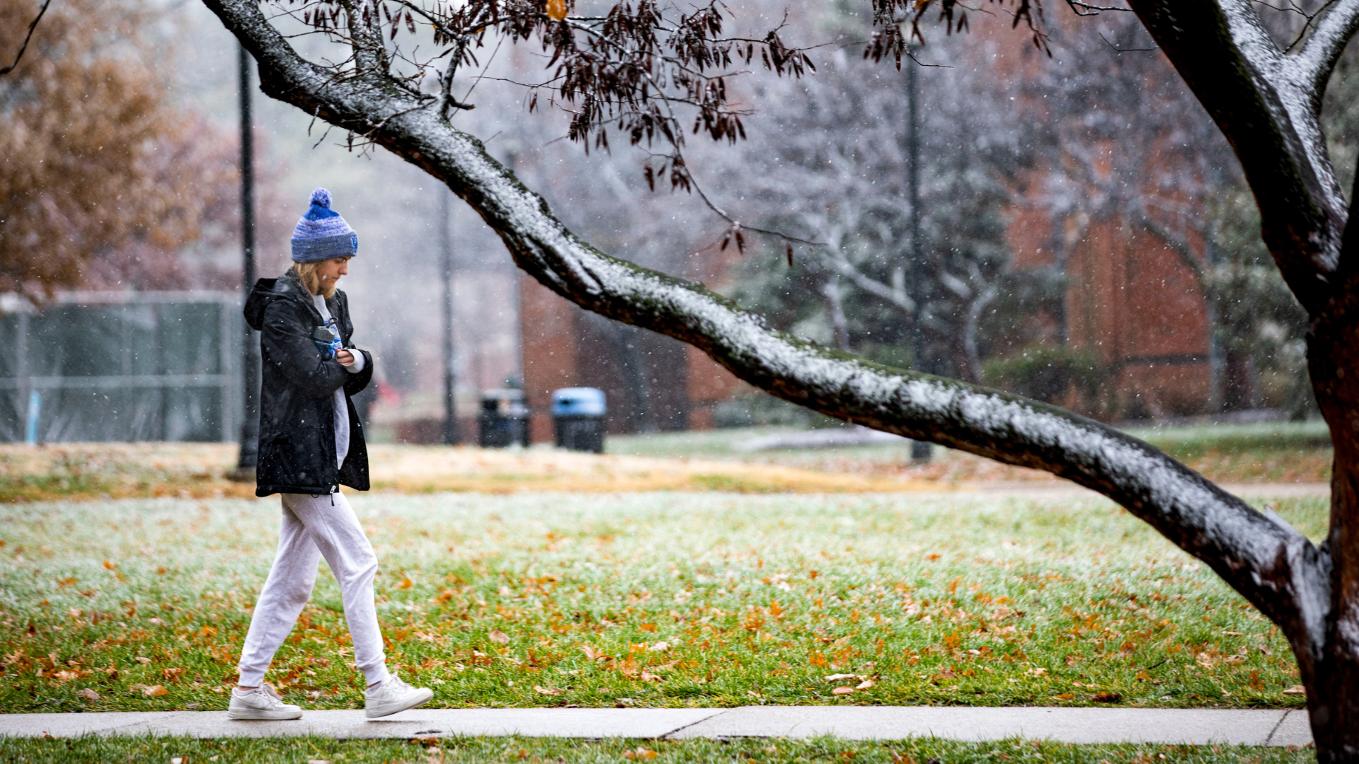 student walking across campus in the snow