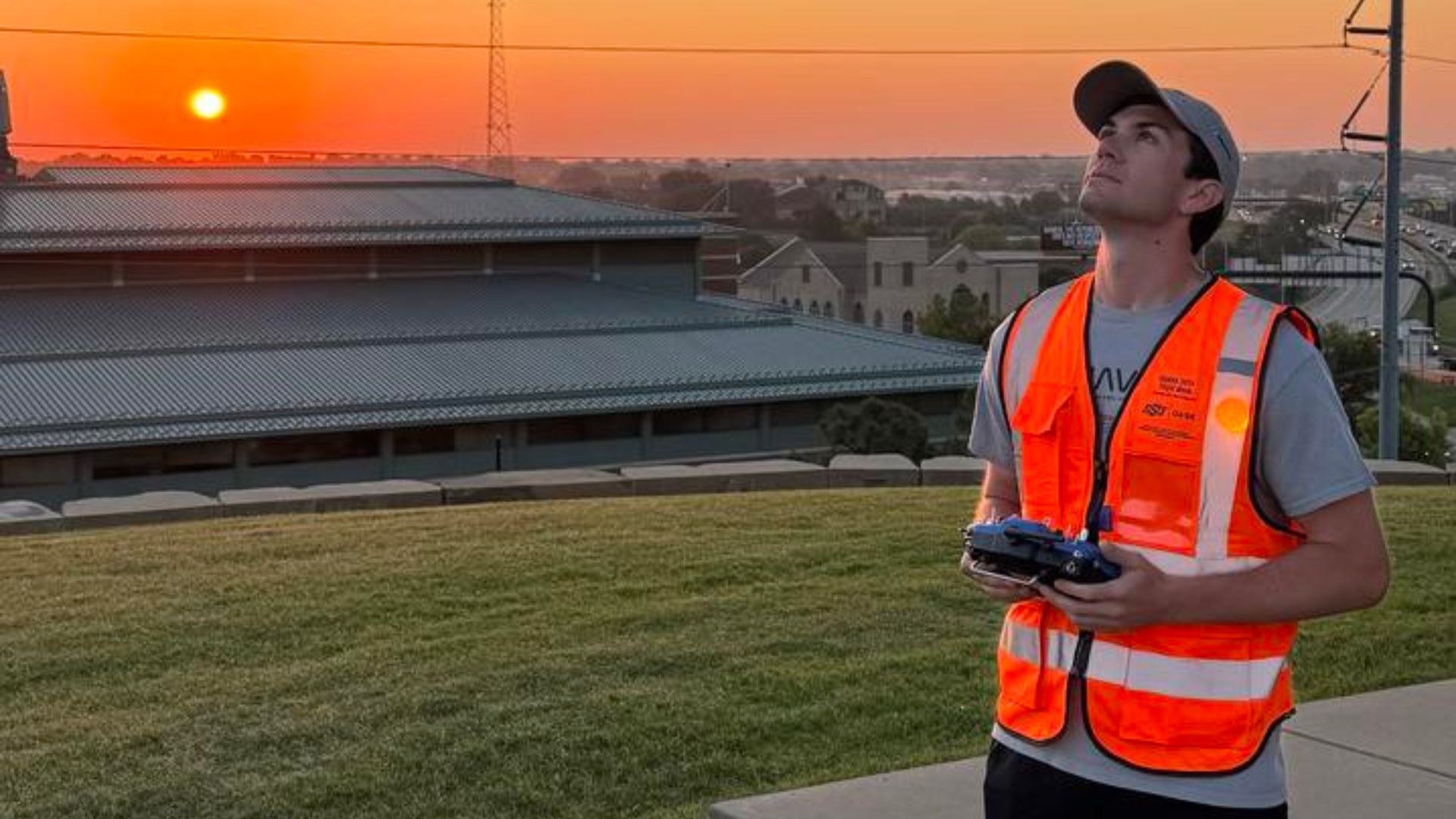 Asa O'Neal looks up to the sky while piloting a drone