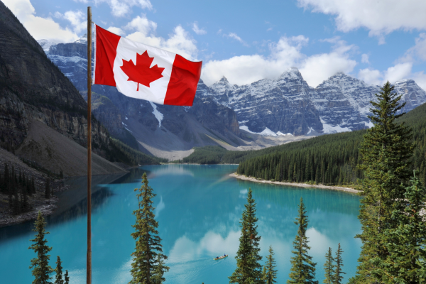 Photo of trees and lake with Canadian flag