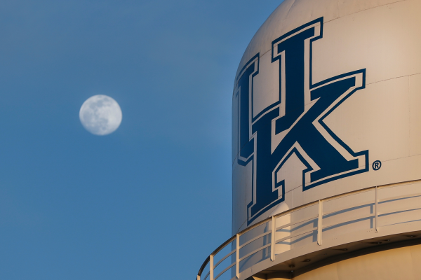Water tower with UK logo and moon in the background