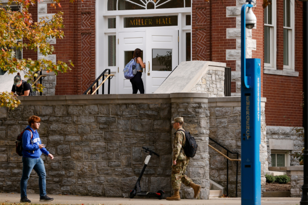 Four students walking around Miller Hall (building on campus)