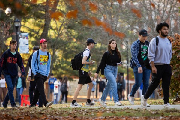 Group of student walking across campus in the fall