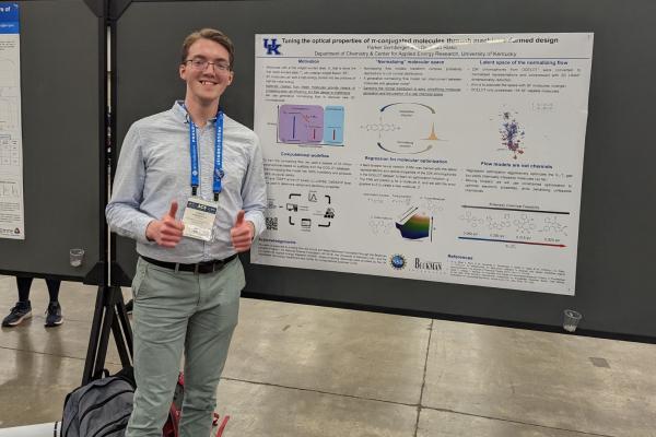 Parker Sornberger in front of research poster