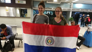Fulbright recipients holding flag of Paraguay