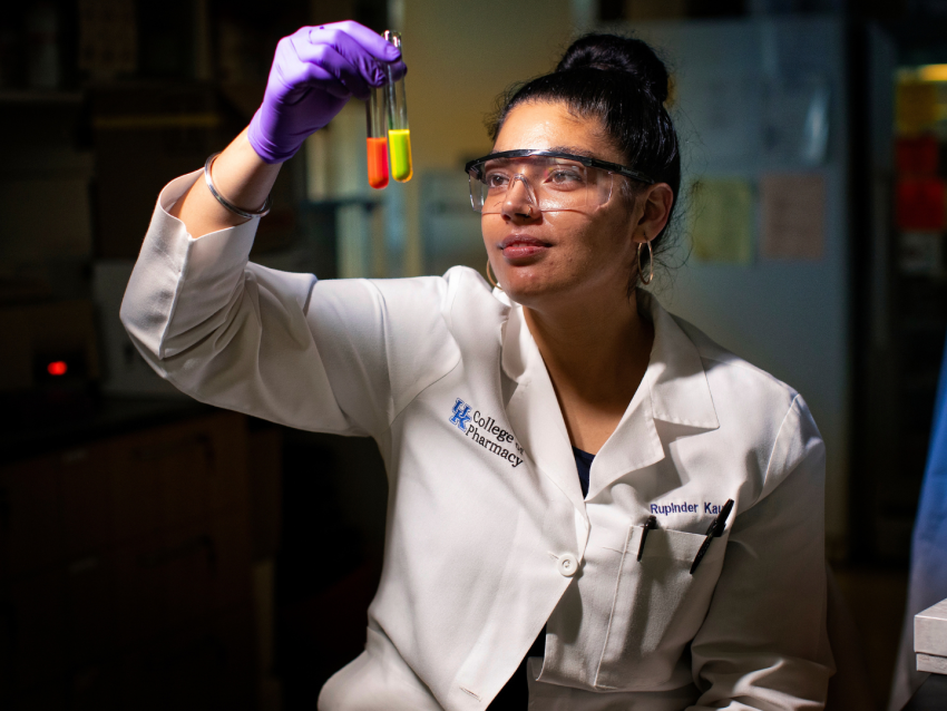 College of Pharmacy student looking up at test tubes