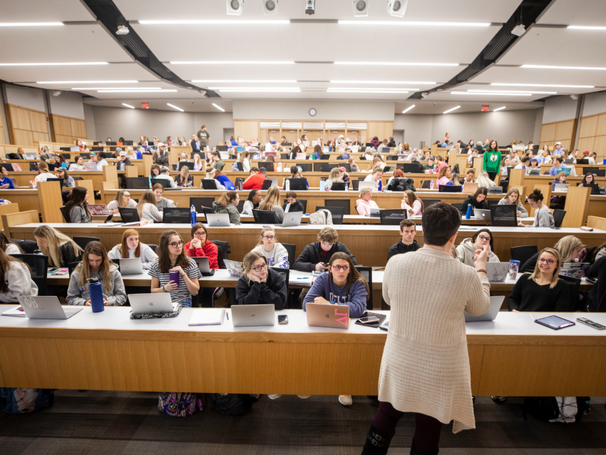 photo of instructor standing in front of a classroom of students