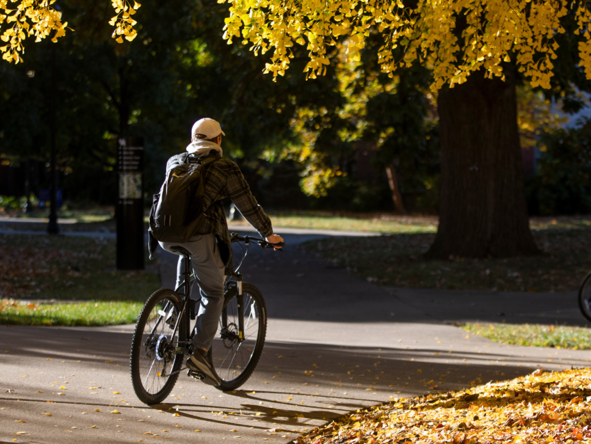 Student riding bike on campus