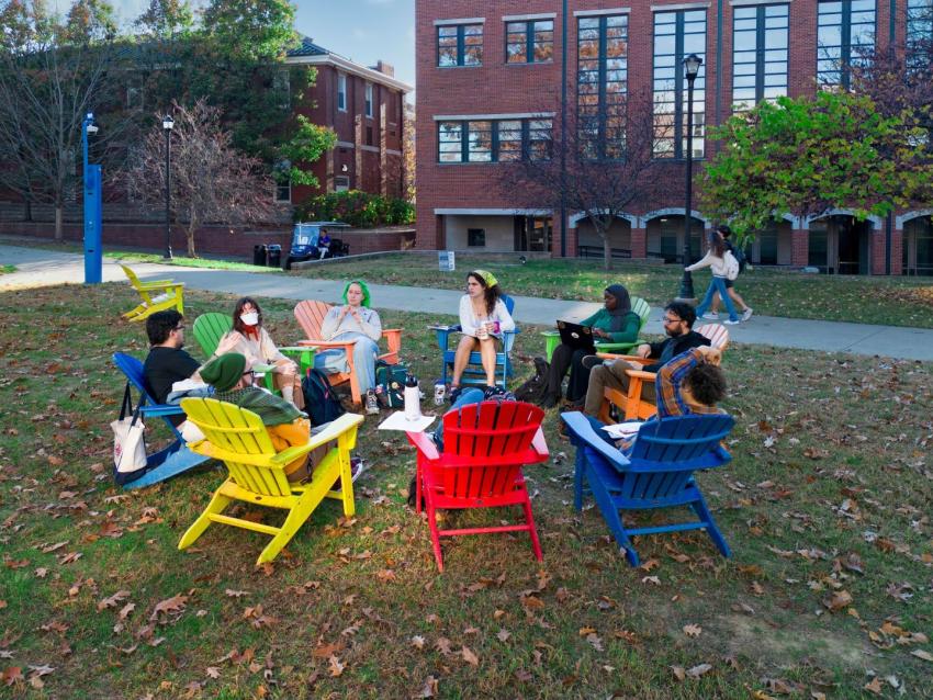 students sitting in a circle outside