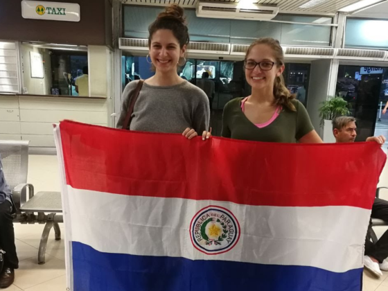 Fulbright recipients holding flag of Paraguay