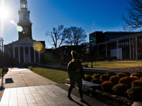 Student walking on path in front of Memorial Hall on UK's campus