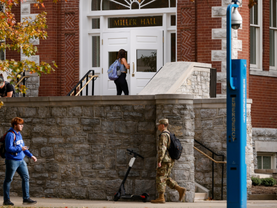 Four students walking around Miller Hall (building on campus)