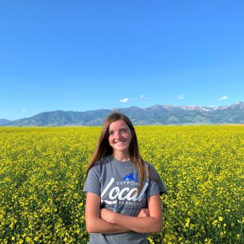 Rebecca Caldbeck in front of field of flowers