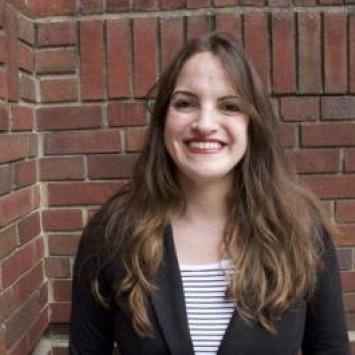 Anahid Matossian headshot in front of brick wall