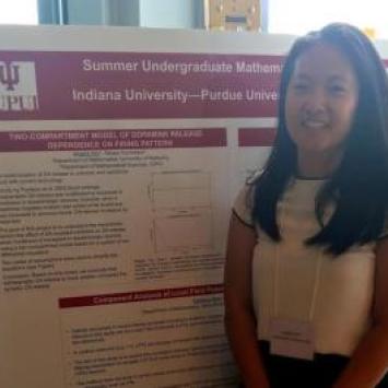 Angela Wei in front of research poster