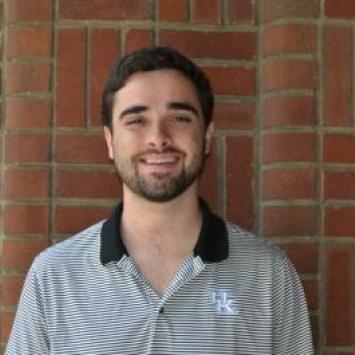 Ben Children headshot in front of brick wall