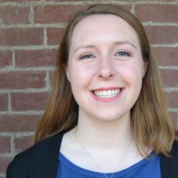 Bridget Nicholas headshot in front of brick wall