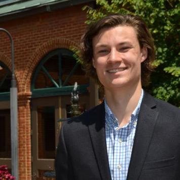 Alston Croley in front of brick building