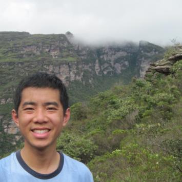 Edward Lo in front of mountain and trees