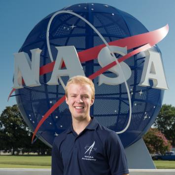 James Tyler Nichols in front of NASA globe