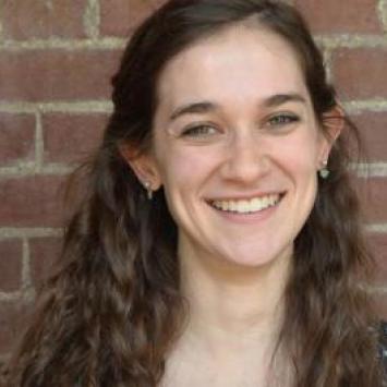 Lydia Hager headshot in front of a brick wall