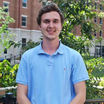 Sam Thompson in front of residence hall