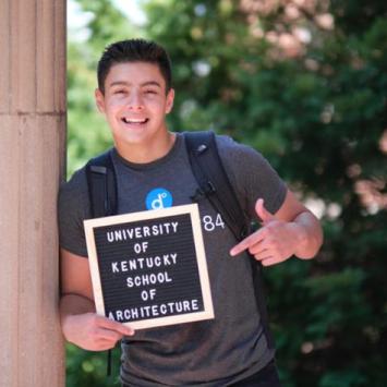 Erik Osorio-Cruz holding board that says "University of Kentucky School of Architecture"