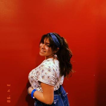 Photo of Daniela Torres-Gomez in front of red wall