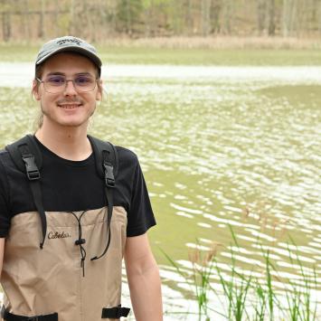 Alex Stewart standing in front of body of water