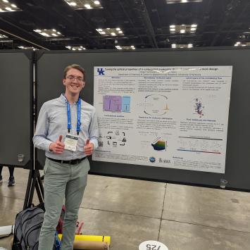 Parker Sornberger in front of research poster