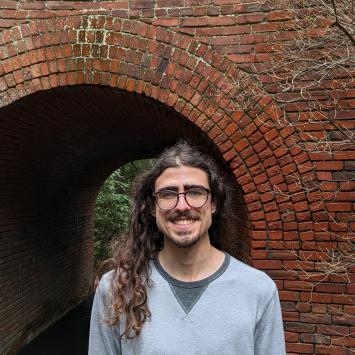 Ryan Sarhan standing in front of brick arch