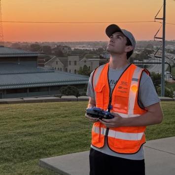 Asa O'Neal flying a drone outside